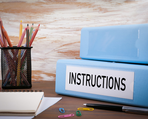 Instructions Office Binder on Wooden Desk on the Table Colored
