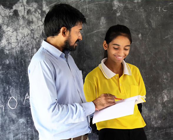 Young Male Lecturer Helping Student During his Class